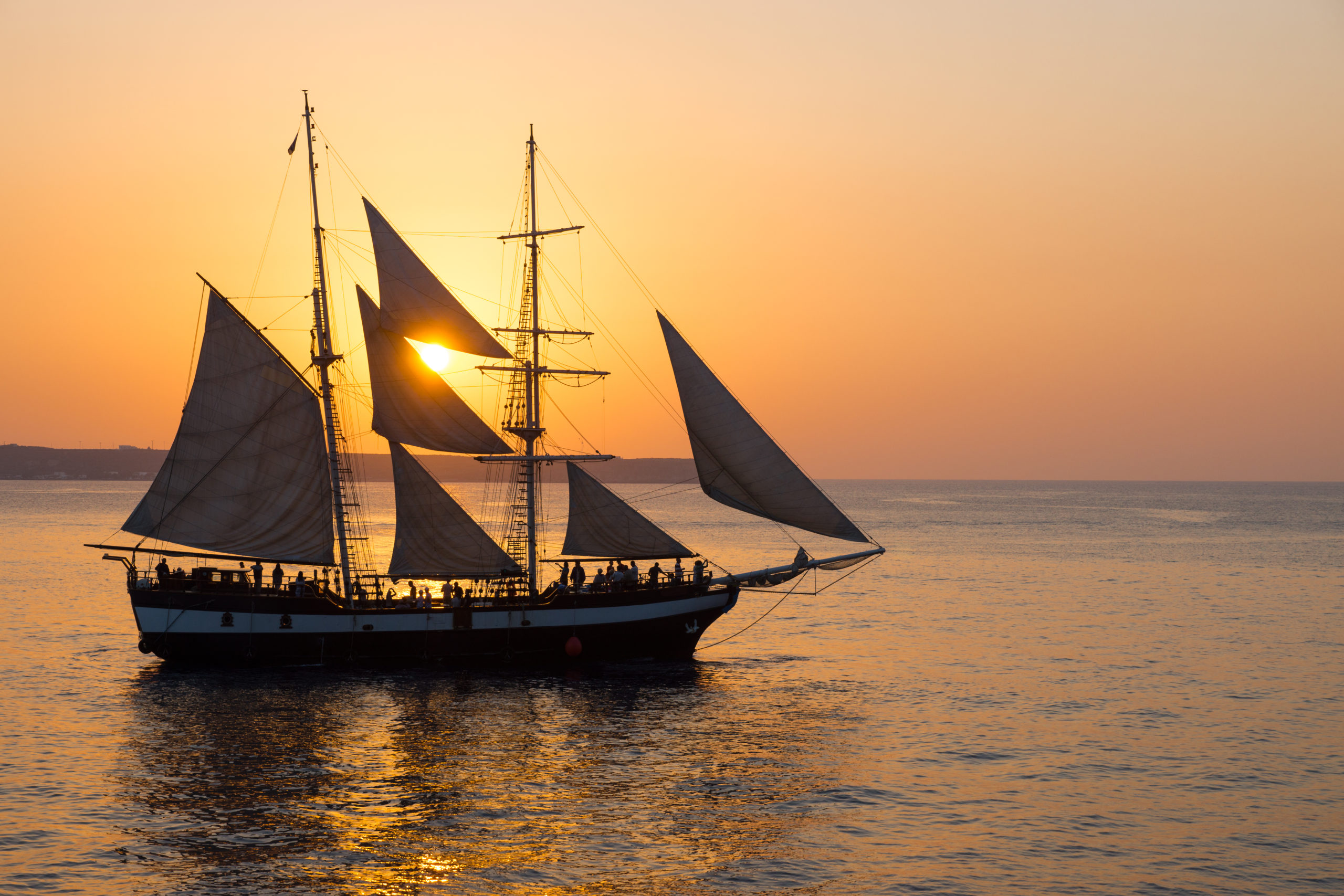 sailing-ship-at-sunset-P6U4ECE-scaled
